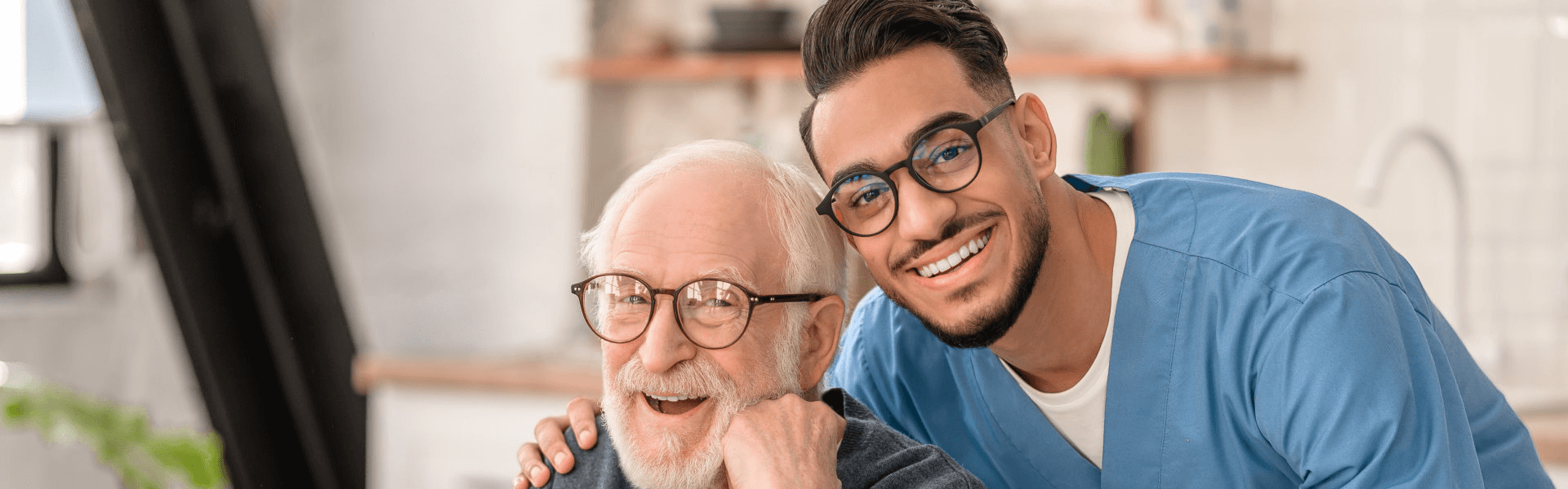 male caregiver and elderly smiling happily